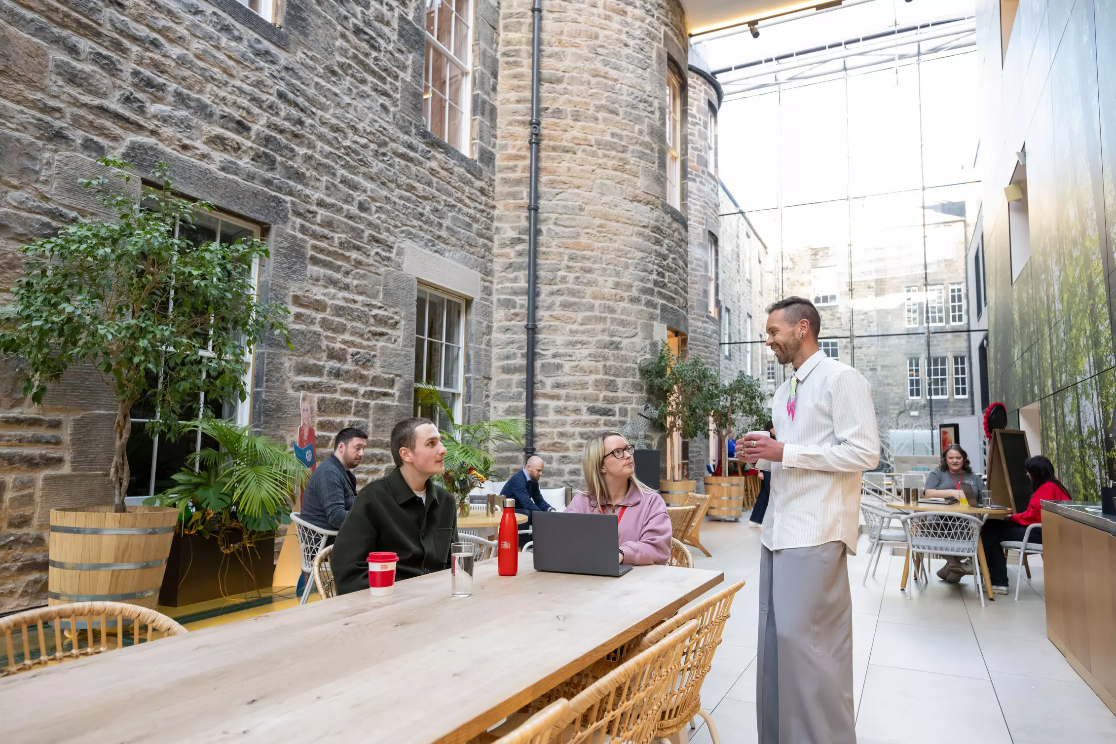 Employee standing at their desk, wearing headphones