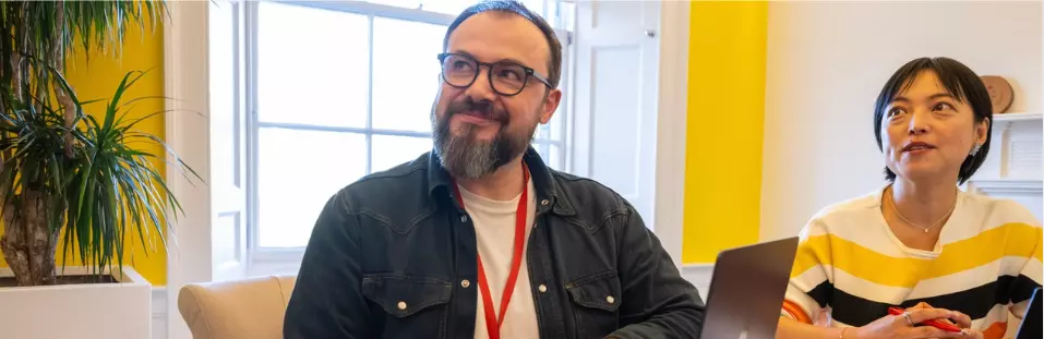 Employee working on their laptop at a desk in the office