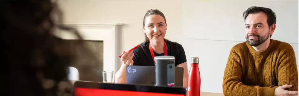 Employee working on their laptop at a desk in the office