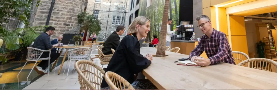 Two employees sitting on chairs in the office