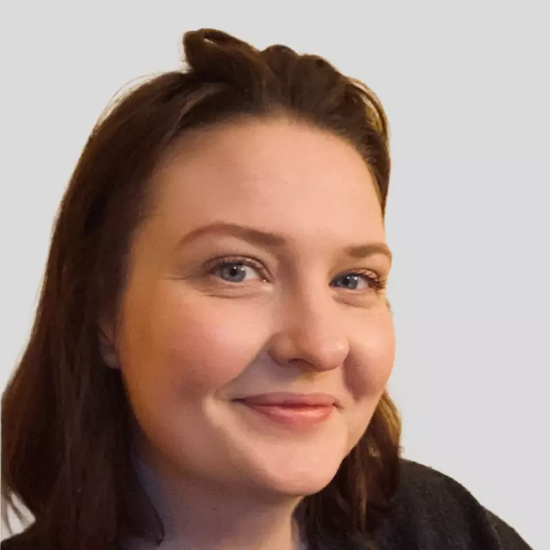 Employee headshot, standing in front of a white background